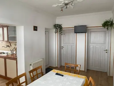 a kitchen and a dining room with a table and chairs at Guest House Simona in Sapareva Banya