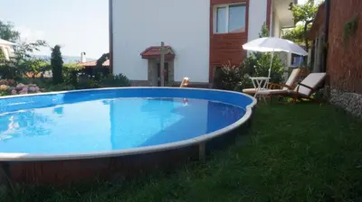 a swimming pool in the backyard of a house at Guest House Simona in Sapareva Banya
