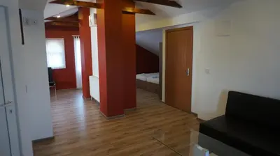 a room with a hallway with a staircase and a room with a door at Guest House Simona in Sapareva Banya