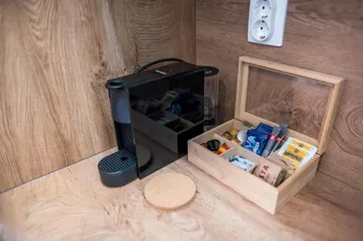 a black router sitting on the floor next to a box at ARHEYA 2 apart АРХЕЯ 2 апартамент за гости in Karlovo