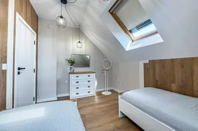 a bedroom with a bed and a skylight at ARHEYA 2 apart АРХЕЯ 2 апартамент за гости in Karlovo