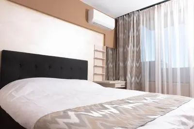 a bedroom with a large bed and a window at Apartment Maritsa View 2 in Plovdiv