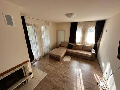 a living room with a couch and a fireplace at Апартаменты Гранд Ризорт с камином и видом на лес in Pamporovo