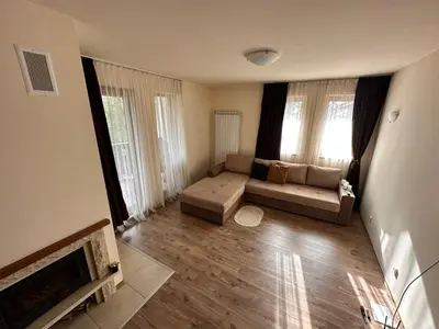 a living room with a couch and a fireplace at Апартаменты Гранд Ризорт с камином и видом на лес in Pamporovo