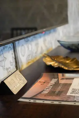 a table with a display case with a plate of food at Pirin Elegance Apartment by Gondola Lift in Bansko