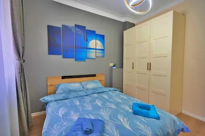 a bedroom with a blue bed with blue pillows at The Heart of Sofia just steps away from Vitoshka in Sofia