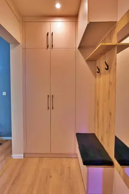 a room with white cabinets and a black bench at The Heart of Sofia just steps away from Vitoshka in Sofia