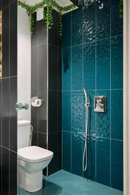 a bathroom with a toilet and a shower with blue tiles at N9 Studentski Loft - Cozy Apt with Private Parking in Sofia