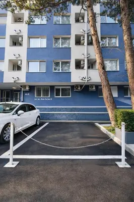 a car parked in a parking lot in front of a building at N9 Studentski Loft - Cozy Apt with Private Parking in Sofia
