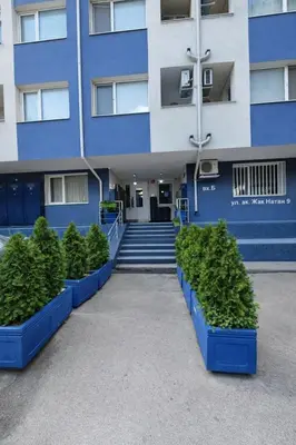 a building with blue planters in front of it at N9 Studentski Loft - Cozy Apt with Private Parking in Sofia