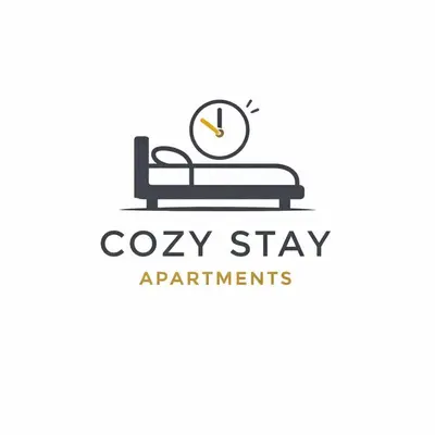 a clock on a bed with the words cay stay apartments at N9 Studentski Loft - Cozy Apt with Private Parking in Sofia