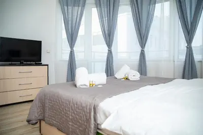 a bedroom with a bed with pillows and a television at Central Sofia Apartment & FREE Underground Garage in Sofia