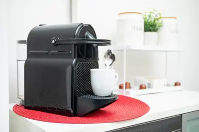 a coffee machine sitting on a counter with a cup at Central Sofia Apartment & FREE Underground Garage in Sofia