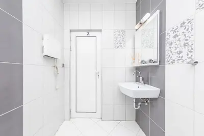 a white bathroom with a sink and a mirror at Central Sofia Apartment & FREE Underground Garage in Sofia