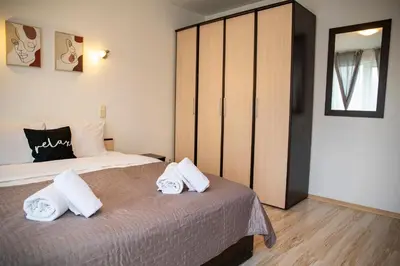 a bedroom with a bed with two white towels on it at Central Sofia Apartment & FREE Underground Garage in Sofia