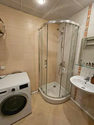 a washing machine in a bathroom with a shower at Charming Apartment Borovets Gardens D16 in Samokov