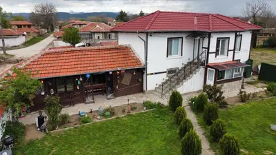 a large white house with a red roof at Дядо Пановата къща