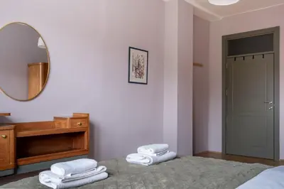 a bedroom with a mirror and towels on a bed at Retro-Chic 1BR Apartment next to Vasil Levski Blvd by Flat Mаnager in Sofia