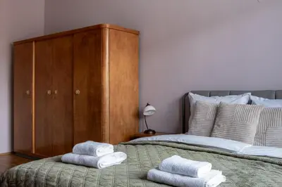 a bedroom with a bed with towels on it at Retro-Chic 1BR Apartment next to Vasil Levski Blvd by Flat Mаnager in Sofia