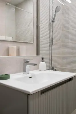 a bathroom with a white sink and a shower at Retro-Chic 1BR Apartment next to Vasil Levski Blvd by Flat Mаnager in Sofia