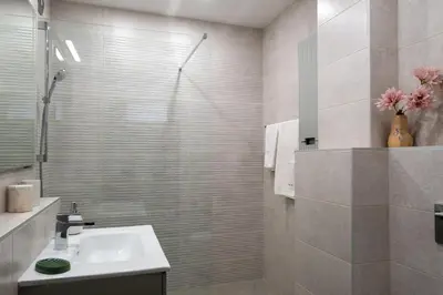 a bathroom with a sink and a shower at Retro-Chic 1BR Apartment next to Vasil Levski Blvd by Flat Mаnager in Sofia
