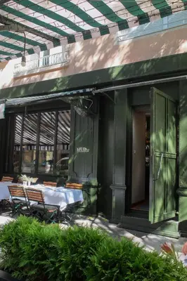 an outdoor patio with a table and chairs on a building at Retro-Chic 1BR Apartment next to Vasil Levski Blvd by Flat Mаnager in Sofia