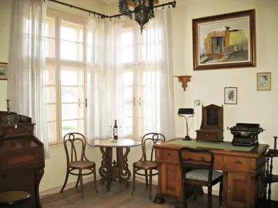 a room with a table and chairs and a window at Maritsa River Apartment in Plovdiv