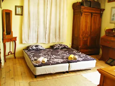 a bed sitting in a room with a window at Maritsa River Apartment in Plovdiv