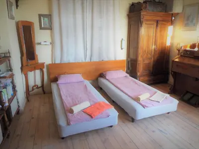 a bedroom with two beds and a dresser at Maritsa River Apartment in Plovdiv