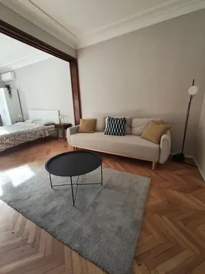 a living room with a couch and a table at Serenity Lodge, close to NDK! in Sofia