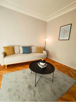 a living room with a couch and a coffee table at Serenity Lodge, close to NDK! in Sofia
