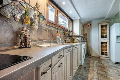 a kitchen with a sink and a refrigerator at Villa TIANA Bansko 7-Bedroom Luxury Chalet in Bansko