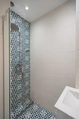 a bathroom with a shower with blue and white tiles at Stylish & Funcional 1 BDRM apt in Sofia's heart in Sofia
