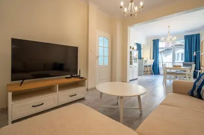a living room with a large flat screen tv at Stylish & Funcional 1 BDRM apt in Sofia's heart in Sofia