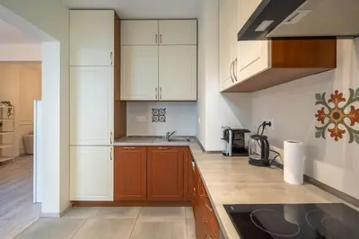 a kitchen with white cabinets and a sink at Stylish & Funcional 1 BDRM apt in Sofia's heart in Sofia