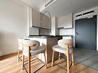 a kitchen with white cabinets and stools in a room at Hotel HAYASHI - Free Parking and Fitness in Sofia