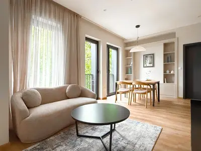a living room with a couch and a table at Hotel HAYASHI - Free Parking and Fitness in Sofia