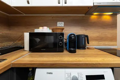 a microwave sitting on top of a kitchen counter at City Retreat with Local Charm in Plovdiv