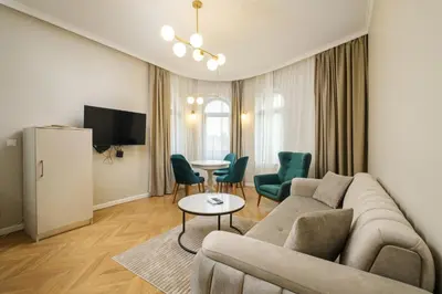 a living room with a couch and a table and chairs at The House of Pom in Plovdiv