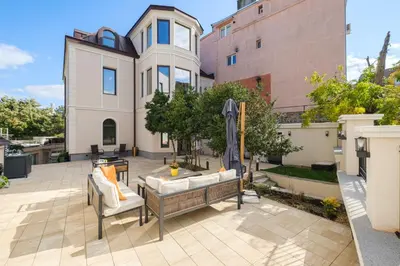 a patio with two chairs and a table in front of a house at The House of Pom in Plovdiv