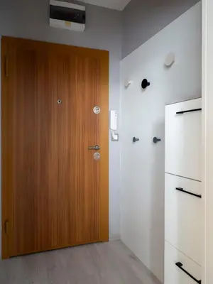 a room with a wooden door and white walls at Modern Vitosha View Apartment with Free Parking in Sofia