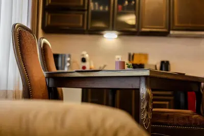 a wooden table and chairs in a room at 2R Ski - ТуЕр Ски in Smolyan