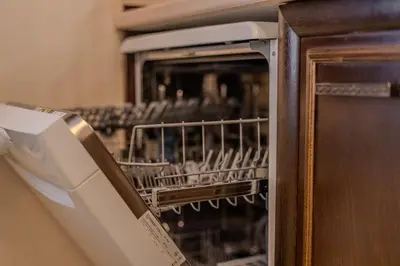 a dishwasher with a dish rack in a kitchen at 2R Ski - ТуЕр Ски in Smolyan