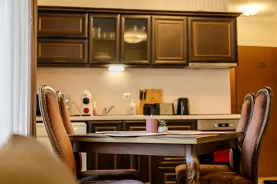 a table and chairs in a kitchen with a counter at 2R Ski - ТуЕр Ски in Smolyan