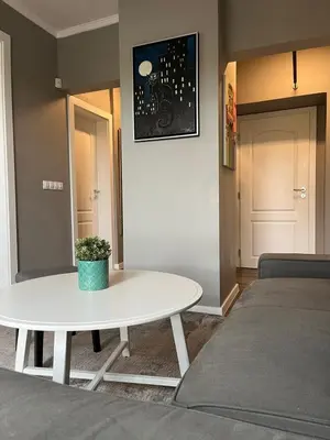 a living room with a white table and a bed at Kate House in Sofia