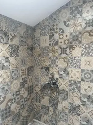 a bathroom with a shower with a tiled wall at Kate House in Sofia
