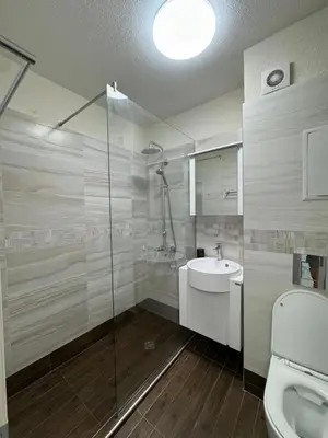 a bathroom with a shower and a sink and a toilet at Top Central Apartment 14 in Sofia