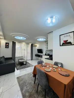 a dining room with a table and a living room at Top Central Apartment 14 in Sofia