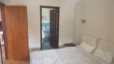 a bedroom with a bed and a door to a closet at Borovets Apartments, Flora Violet Residence in Borovets