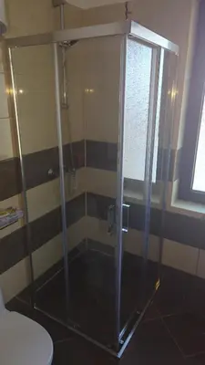 a glass shower in a bathroom with a toilet at Borovets Apartments, Flora Violet Residence in Borovets